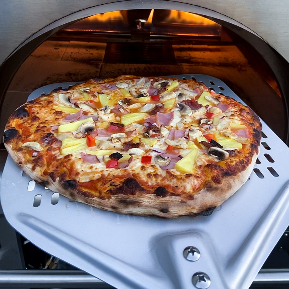 pizza going into pizza oven